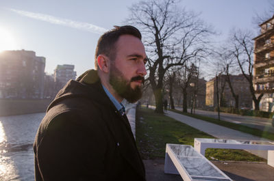 Man in city against sky