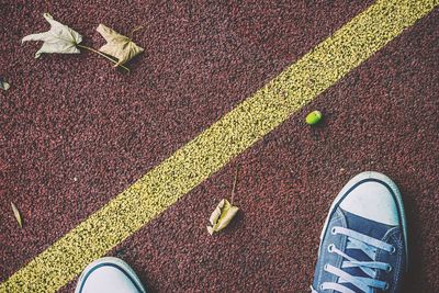 Low section of person standing on tiled floor