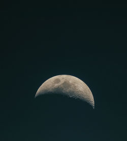 Low angle view of half moon against sky at night