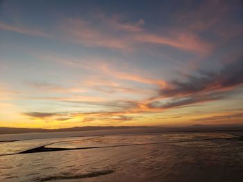 Scenic view of sea against romantic sky at sunset