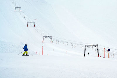 People skiing on snow covered mountain