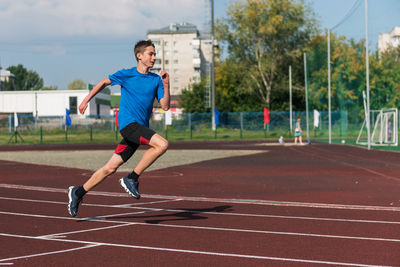 Full length of man exercising on road