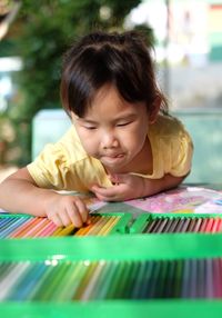 Portrait of cute girl holding colorful table