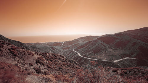 Scenic view of desert against sky during sunset