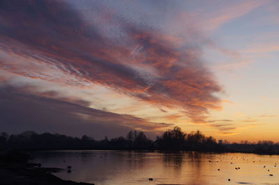 Scenic view of lake against romantic sky at sunset