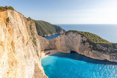 Beautiful view of a deserted beach with a sunken ship.