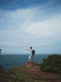 Man playing in sea against sky