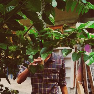 Man standing by leaves