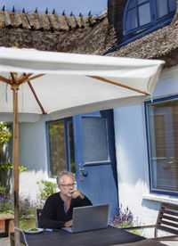 Man using laptop in garden