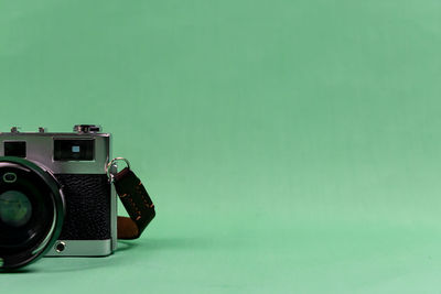 Close-up of camera on table against blue background