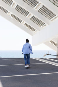 Rear view of man standing on road