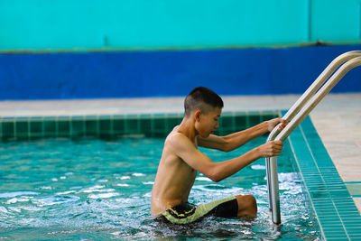 Full length of shirtless boy in swimming pool