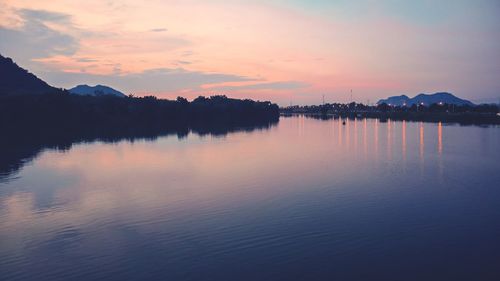 Scenic view of lake against sky at sunset