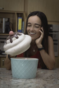 A beautiful woman stealing a cookie from the cookie jar.