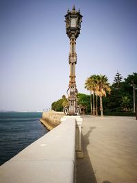 Narrow walkway along calm sea