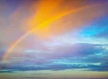 Low angle view of rainbow against sky during sunset