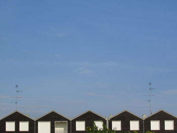 Row houses against clear blue sky