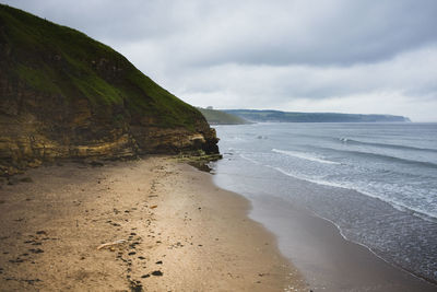 Scenic view of beach against sky at whitby on the north east coast of britain