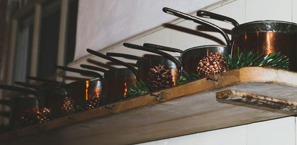 Close-up view of pots on shelf