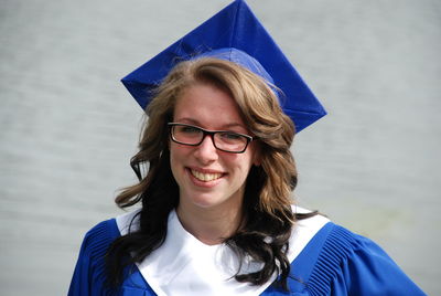 Portrait of smiling woman wearing graduation gown