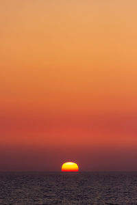 Scenic view of sea against romantic sky at sunset