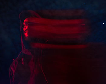 Close-up portrait of man against black background