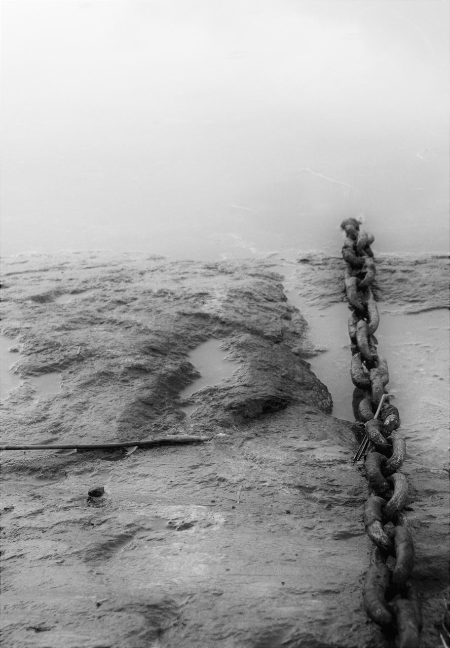 CLOSE-UP OF ROPE AGAINST WATER