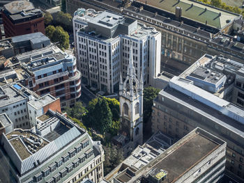 High angle view of old church between modern buildings in london