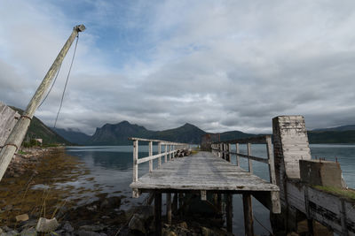 Pier over lake against sky