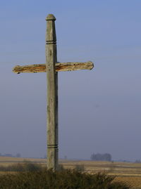 Low angle view of cross against clear blue sky