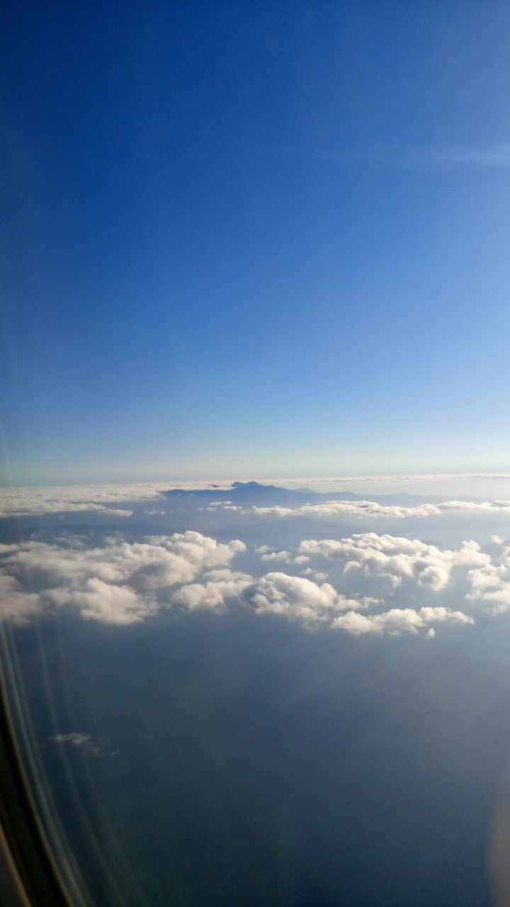 AERIAL VIEW OF CLOUDS OVER LANDSCAPE SEEN FROM AIRPLANE