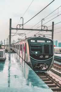 View of railroad tracks in city against sky