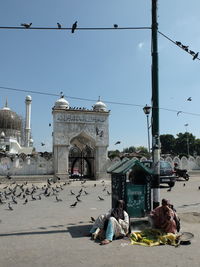 People in city against clear sky