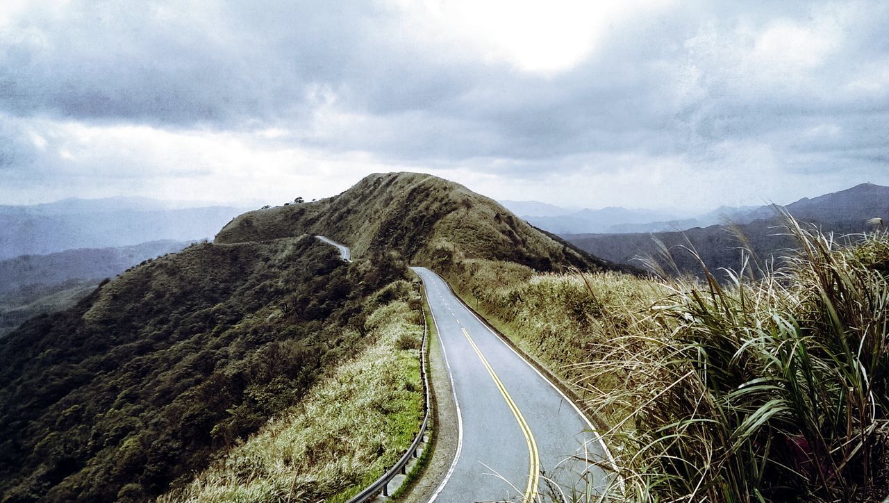 mountain, the way forward, sky, tranquil scene, mountain range, tranquility, landscape, road, cloud - sky, transportation, scenics, diminishing perspective, nature, cloudy, beauty in nature, non-urban scene, cloud, vanishing point, country road, day