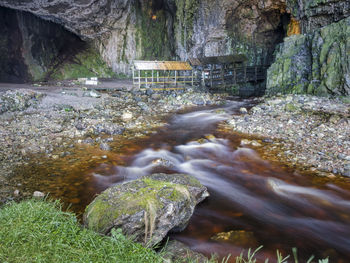 Stream flowing through rocks in forest