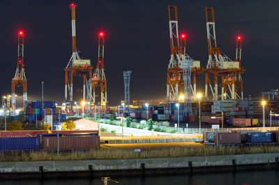 Illuminated pier against sky at night