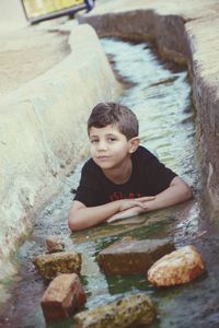 Portrait of cute boy on rock