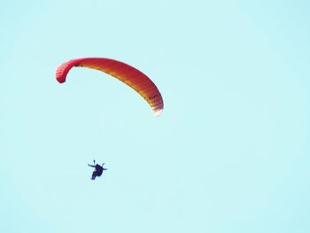 Low angle view of parachute against clear sky