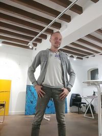 Portrait of young man standing in corridor