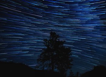 Light trails on landscape at night