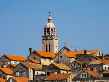 Low angle view of bell tower against blue sky