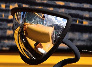 Distorted view of school bus in odd looking mirror