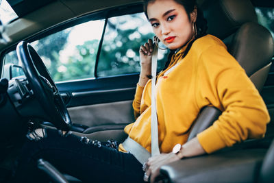 Beautiful woman sitting in car