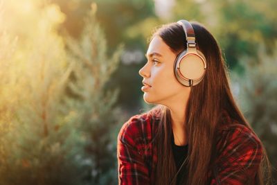 Portrait of young woman looking away outdoors