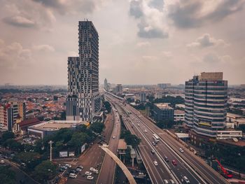 High angle view of street amidst buildings in city against sky