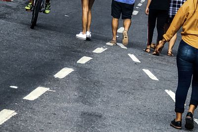 Low section of people walking on road