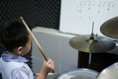 Boy playing drum at home