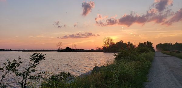 Scenic view of river against sky during sunset