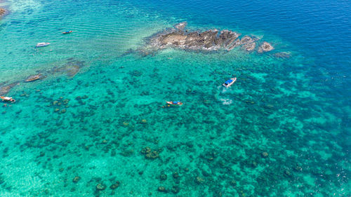 High angle view of people swimming in sea