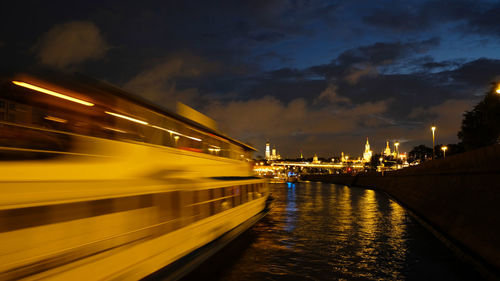 River cruise ship sails along the moscow river, night city, movement by incorporating a motion blur.